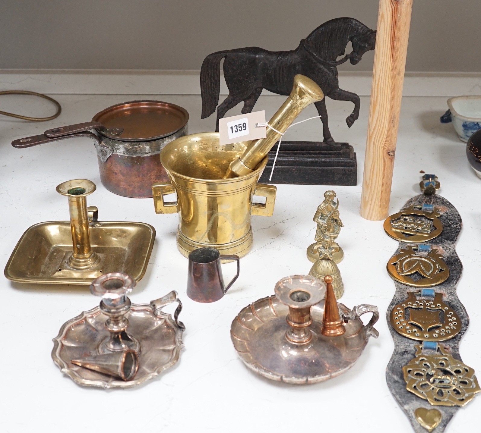 A large brass pestle and mortar and other metalware